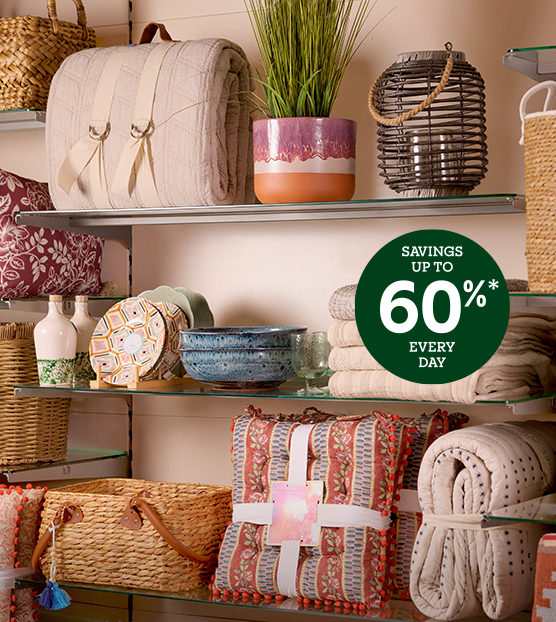 Store shelf with blankets, plates, picnic baskets and plants