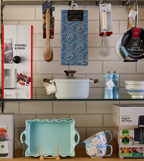A store shelf featuring storage baskets, an iron and utility products