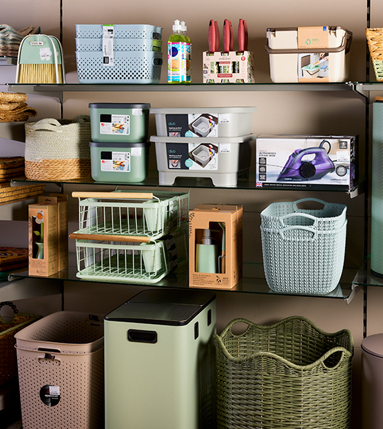 A store shelf featuring kitchen utensils, trays, pans and small appliances