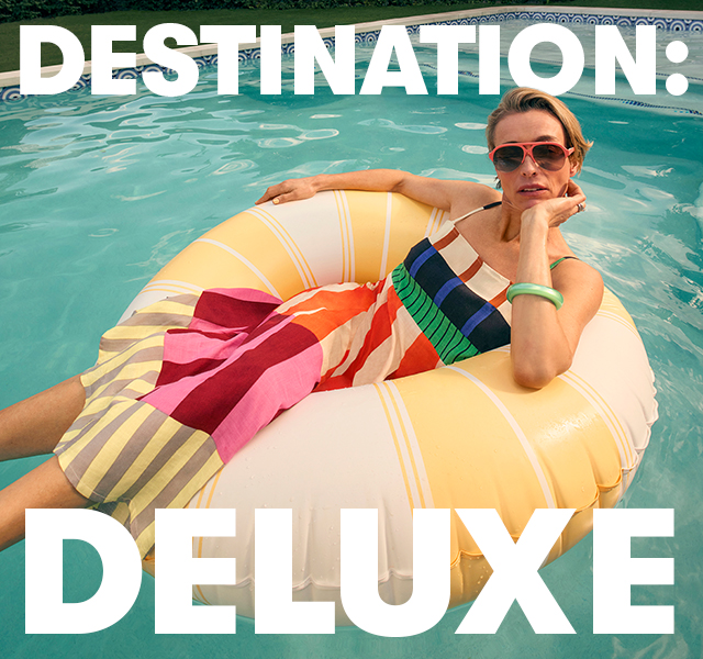 A model wearing a striped dress sat in an inflatable ring in a pool.