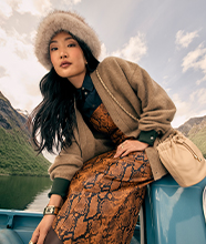 A woman wearing a furry hat and animal-print skirt 