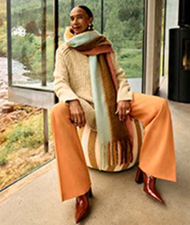 Woman wearing a large knitted scarf.