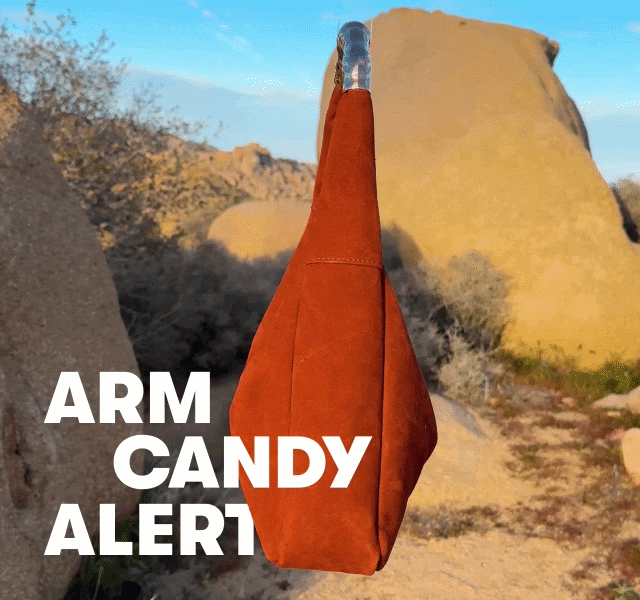 GIF of a spinning orange bag among desert rocks, with “ARM CANDY ALERT” text overlay. 