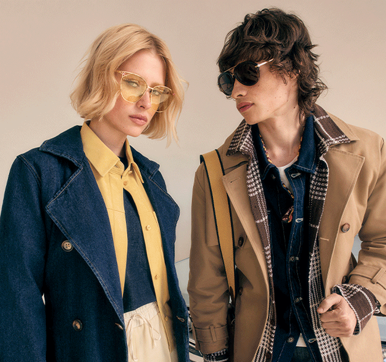 Two models wearing denim and neutral-toned jackets with sunglasses.