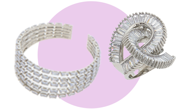 Two pieces of silver jewellery displayed on a light background with a soft purple circle, featuring intricate textured designs and curved shapes.