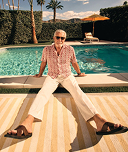 An older man in sunglasses, by a pool