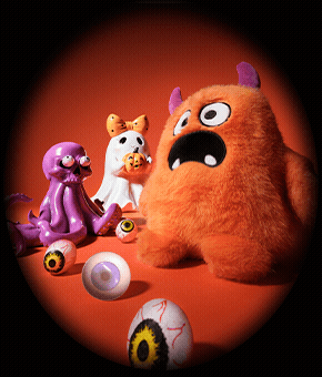 A trio of cute Halloween figures alongside some eyeball-style balls. 