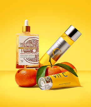 Three oranges with three different vitamin C serums.