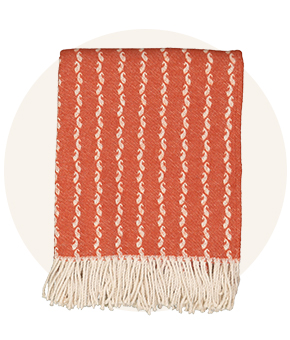 A burnt orange cosy throw. 