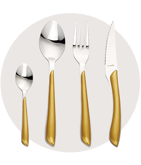 A set of silver cutlery with contrasting gold handles
