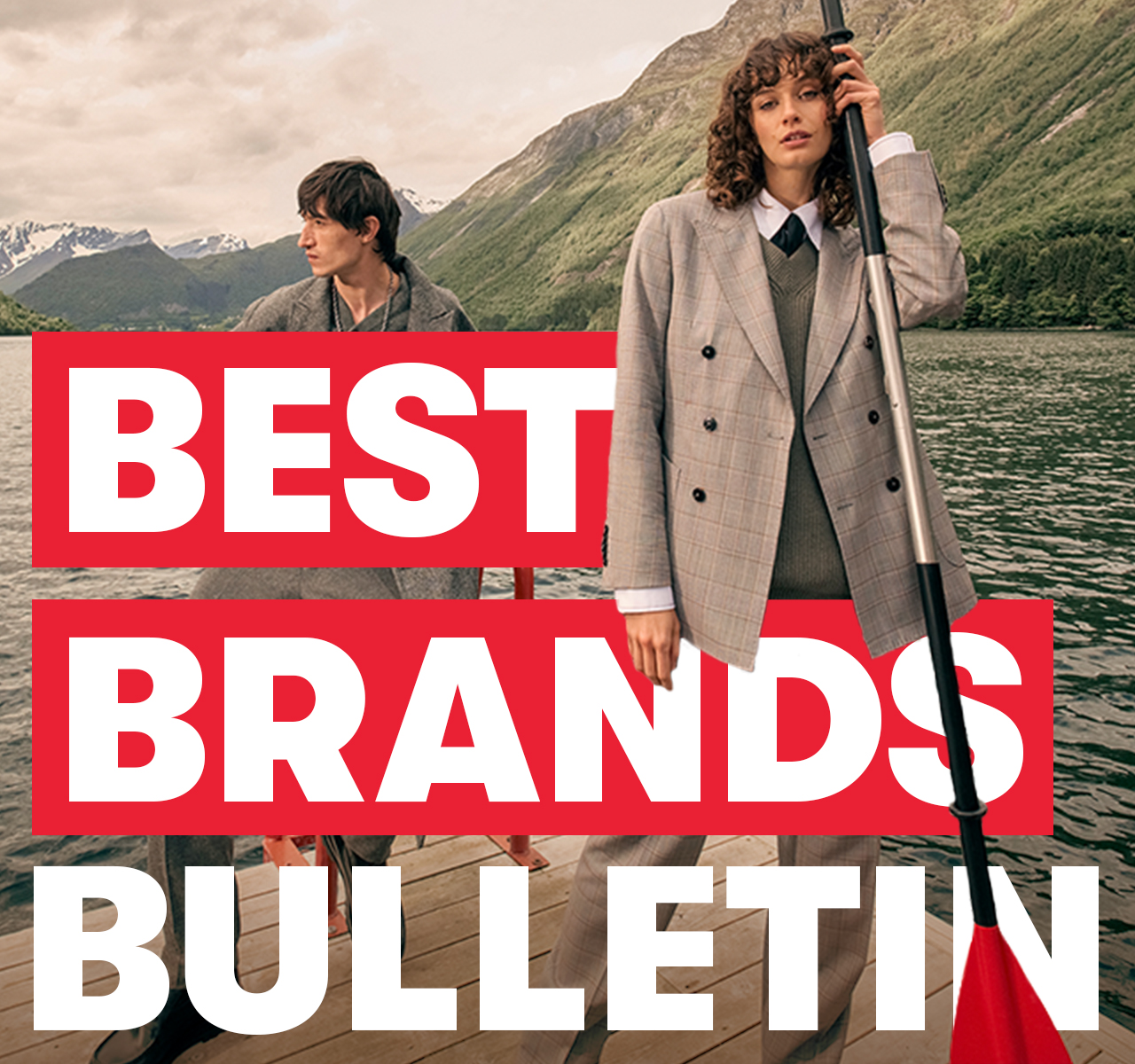 Two people in tailored outfits stand on a lakeside dock with mountains behind them. Text reads: “BEST BRANDS BULLETIN”.