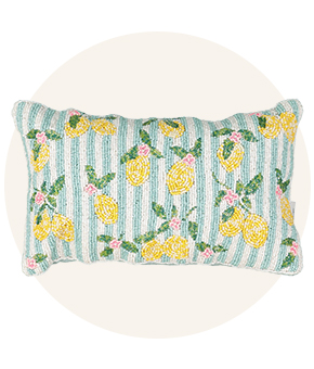 A striped cushion with lemon print detail. 