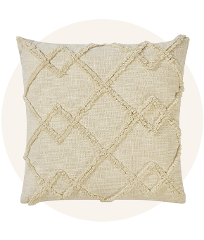 A cream pillow featuring a textured pattern.