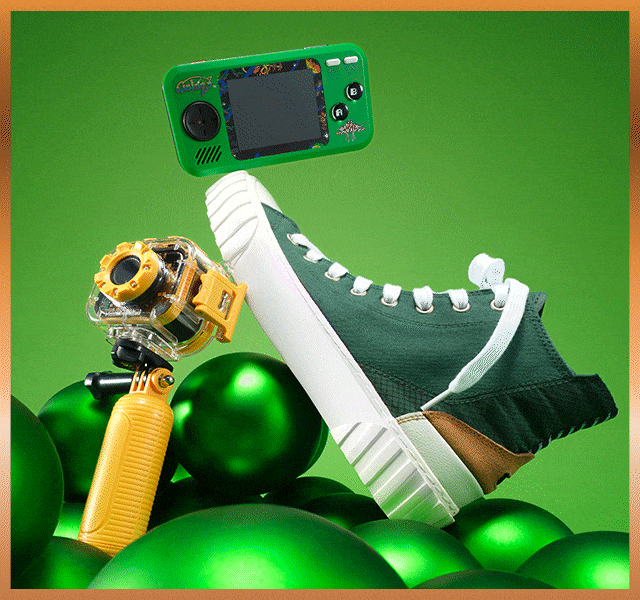Gadgets and trainers on a green background