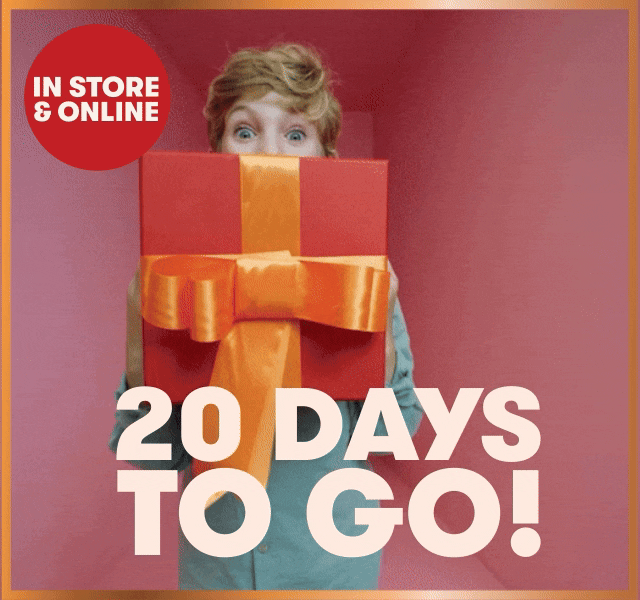 A child carrying a large red gift box with a bright orange bow. 