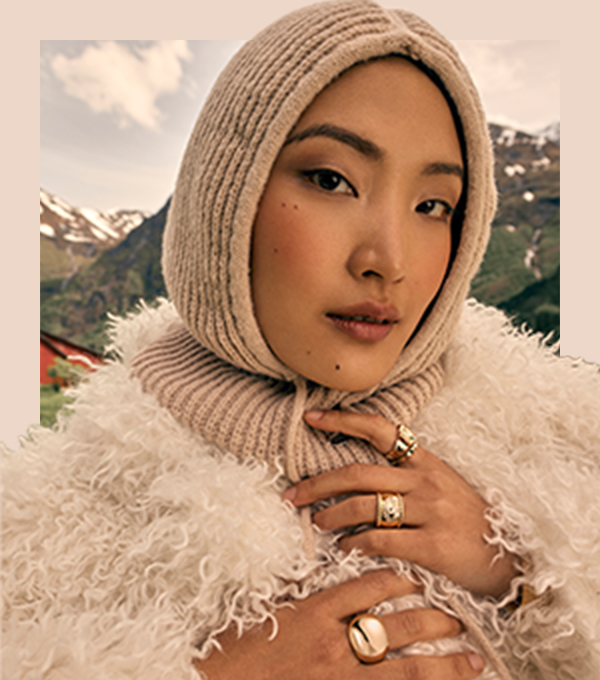 A model wearing a knitted wool bonnet