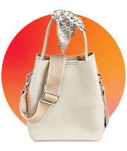 A beige leather bag with a contrasting silk scarf handle. 