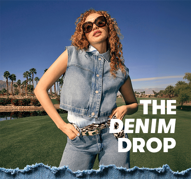A woman wearing a denim waistcoat and matching jeans with a contrasting animal print belt.