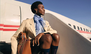 A model sits of the steps leading up to an airplane. 