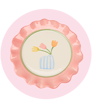 A plate that's painted with flowers in pastel hues.				