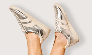 A model wearing metalic silver trainers