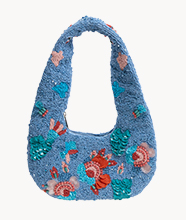 An embroidered shoulder bag against a white background. The bag has blue, teal, red and pink beaded details.