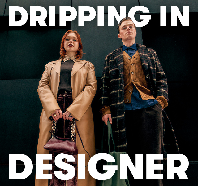 A male and female model wearing luxury staples including a long leather jacket, a checked overcoat and designer bag. 