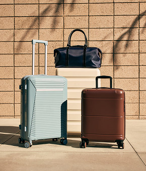 A neutral-toned weekender bag with leather handle and strap.