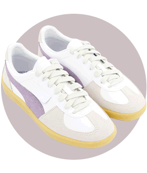 A pair of white trainers with lilac and beige accents and a tan gum sole.
