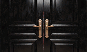 Black doors opening to a TK Maxx store.