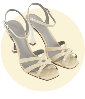 A pair of cream high-heeled sandals.