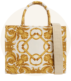 A gold and white tote bag with ornate printed detailing 
