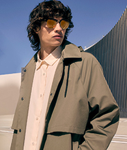 Man wearing green trench coat.