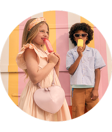 Two kids posing with ice lollies.
