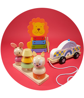 A mixture of wooden kids' toys on a festive red background.