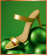 A pair of open-toe gold high heels.