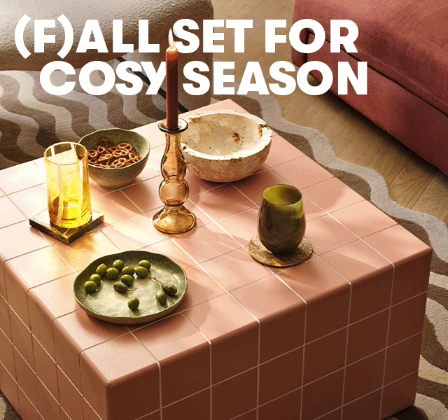 (F)all set for cosy season. Autumn homeware on a tiled coffee table, including candles, glassware and decorative bowls.