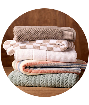 A stack of folded towels in pastel tones. 