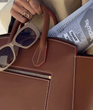 GIF of a brown leather handbag with sunglasses.