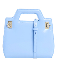 Light blue structured handbag with top handle, gold hardware and strap detail, shown front-on against a plain background. 