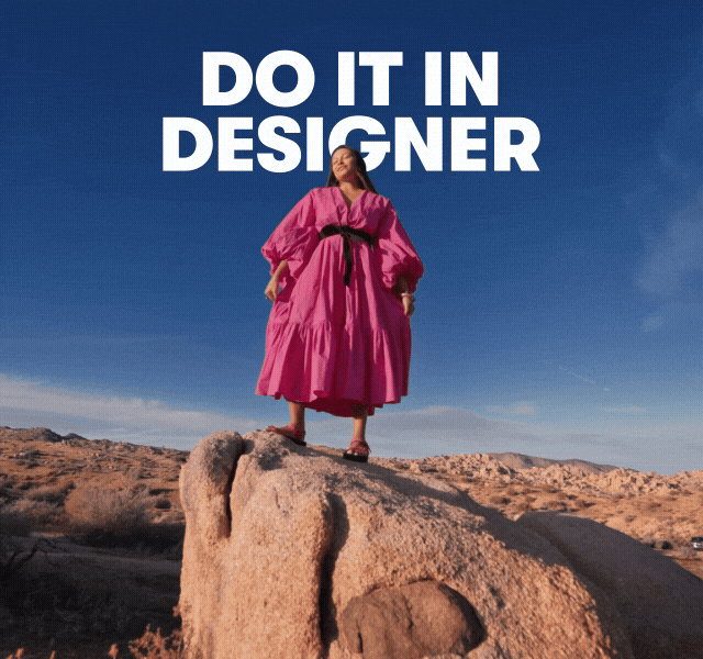 A moving GIF image of a woman with black hair in a pink dress. She poses amid rocky terrain under a blue sky.