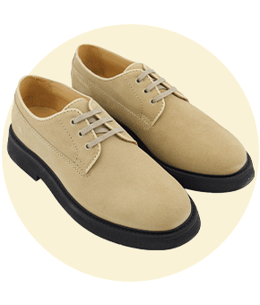 A pair of beige suede brogues.