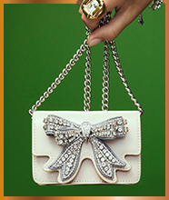 A small shoulder bag with an embellished bow detail.