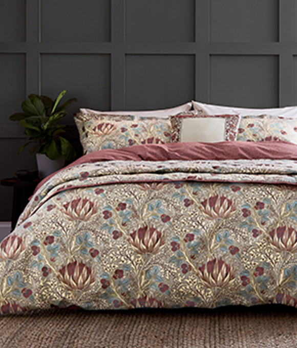 Large bed with patterned bedding.