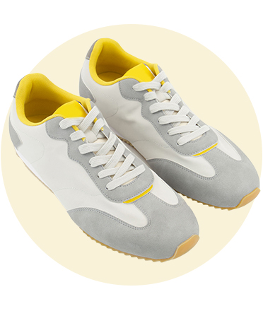 A pair of yellow, grey and white trainers for men.