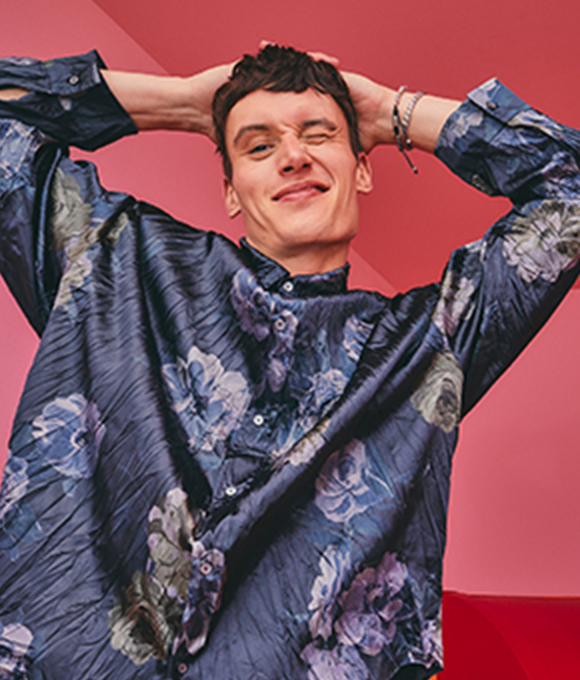 A male model wearing a shiny navy shirt