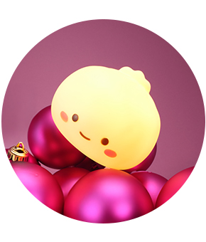 A novelty light-up kids' toy perched on pink baubles.