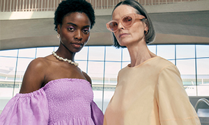 Two models wearing pastel-toned dresses, statement sunnies and a natural pearl necklace.